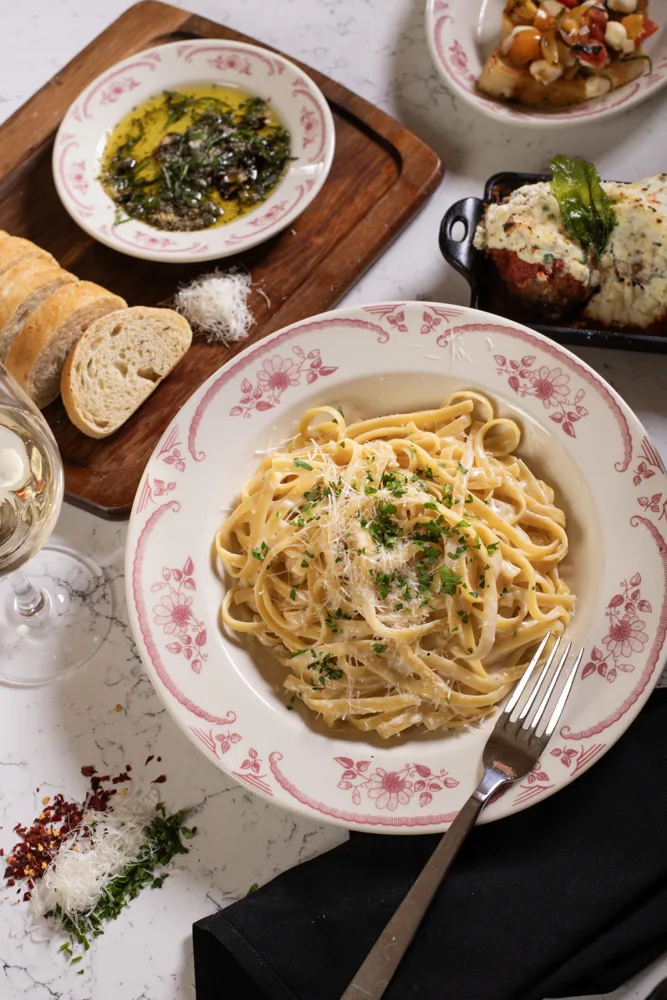 A table of pasta and other dishes at Sortino’s Italian Kitchen in Kalahari Wisconsin